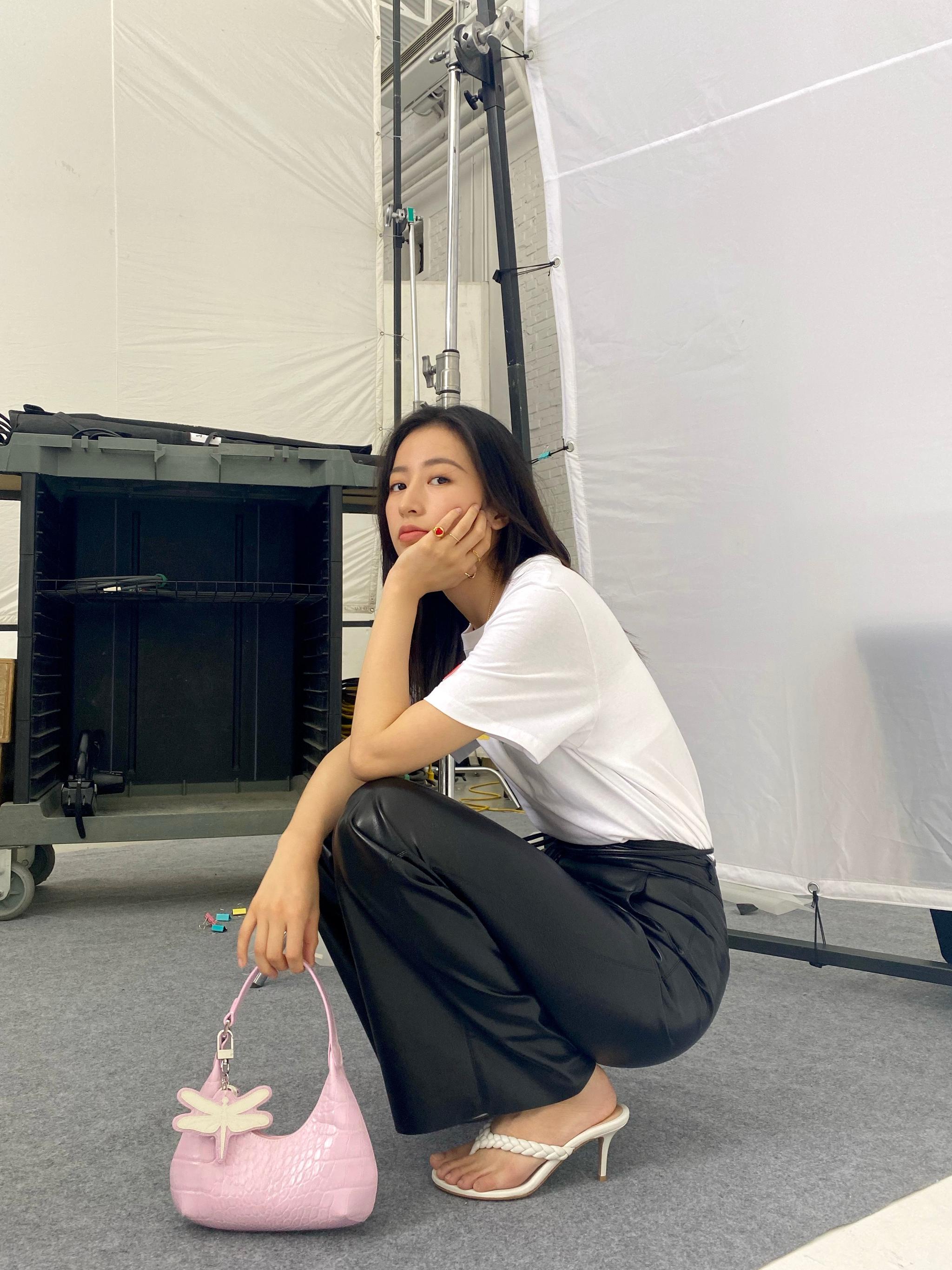 身穿白色t和黑色皮裤