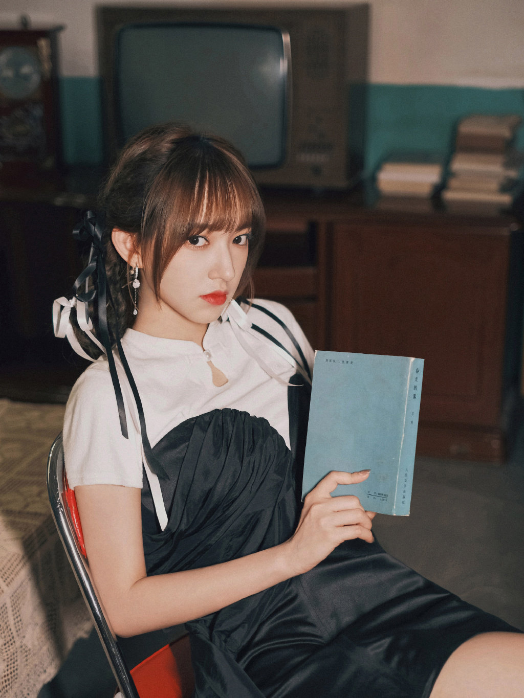 程潇身穿黑白抹胸短裙,俏皮丝带编发,沉浸书香的学生模样