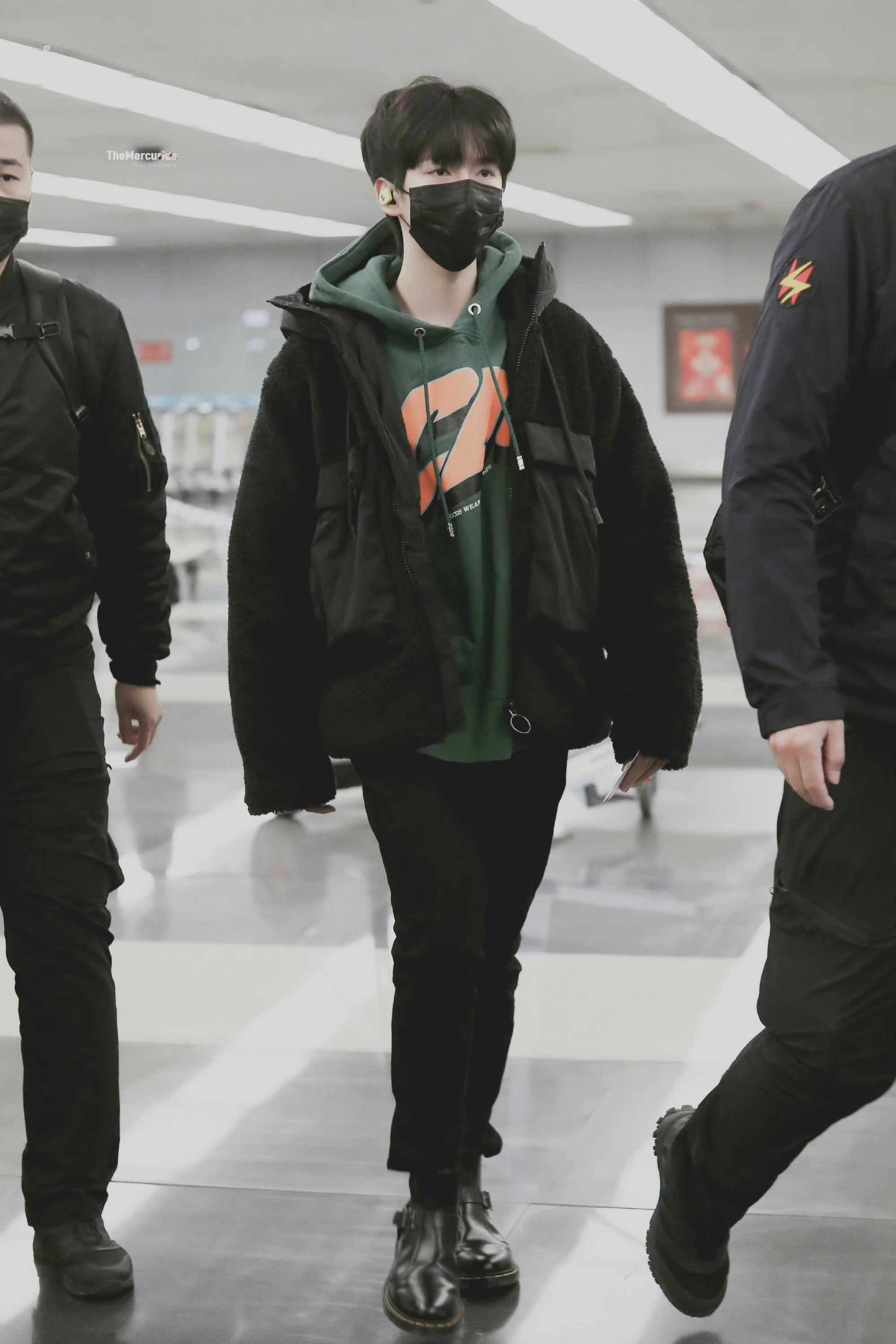 贺峻霖今日份机场出发饭拍图 绿色卫衣 黑色外套 黑皮鞋的小贺