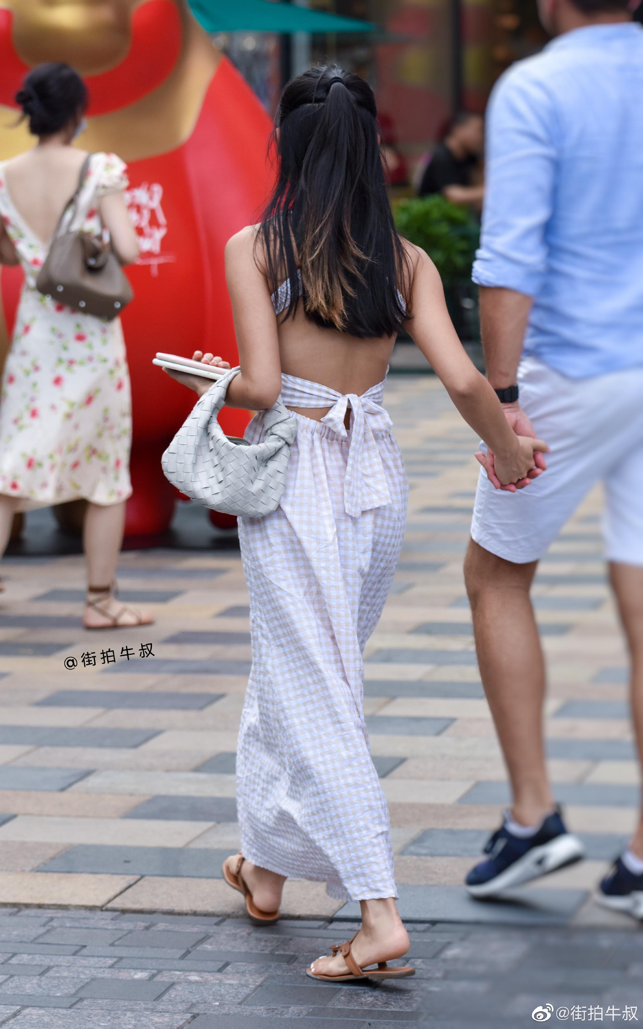 美女穿着性感的露背连衣裙出街