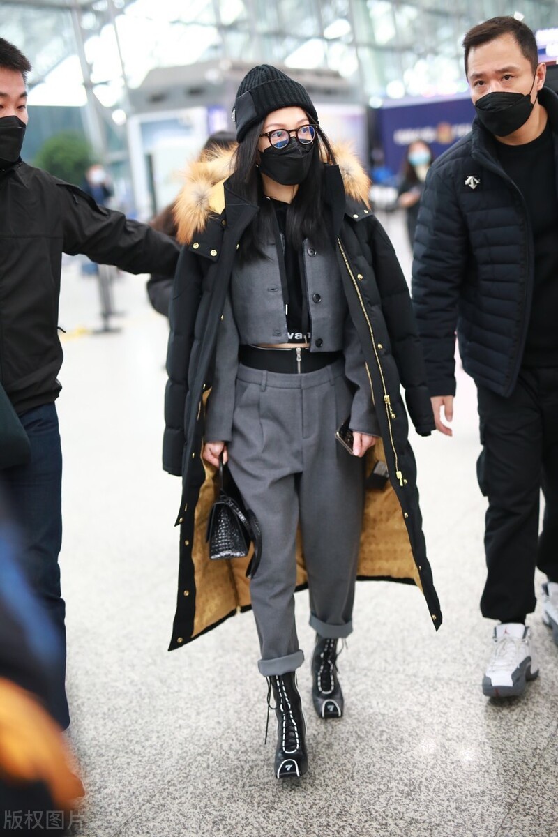张韶涵穿灰色西装裤搭配羽绒服现身机场,元素混搭出风格来