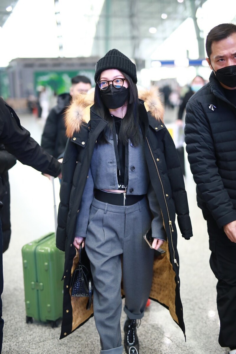 张韶涵穿灰色西装裤搭配羽绒服现身机场,元素混搭出风格来