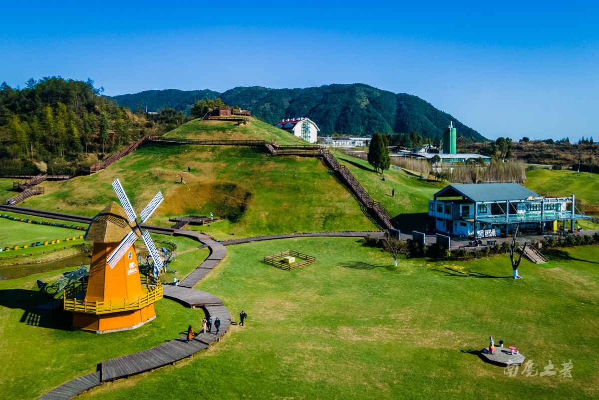 说是牧场,不如说更像休闲度假农庄,缓缓转动的大风车,起伏的山丘,碧绿