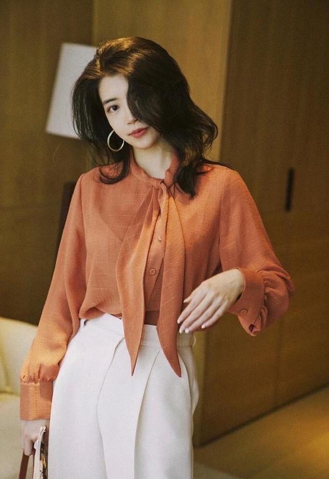 女性的柔美感,同时又减弱了衬衫本身的职业感,搭配一条印花法式半身裙