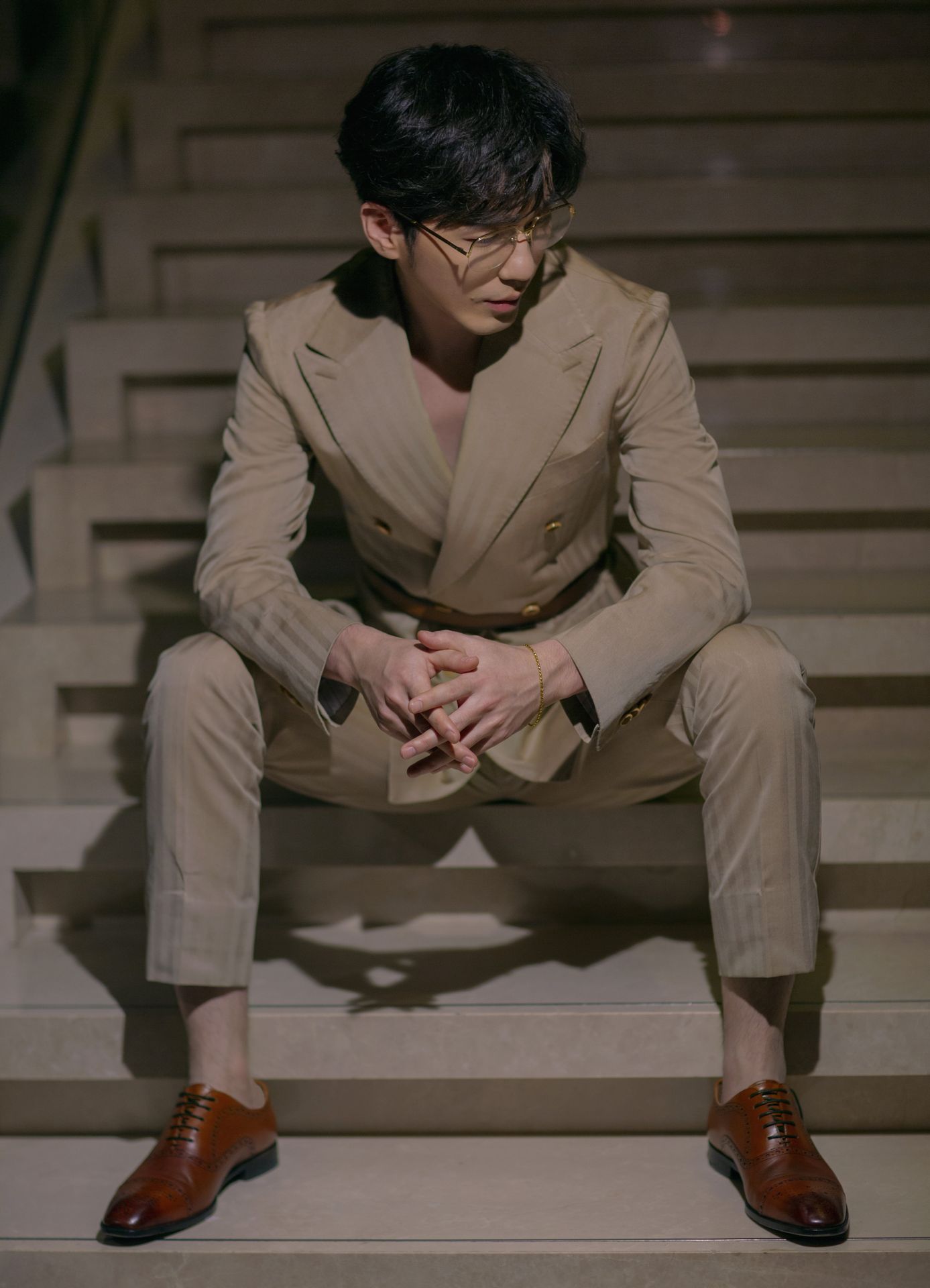 白宇一身卡其色西装,搭配金丝眼镜,尽显本色魅力,痞帅痞帅的
