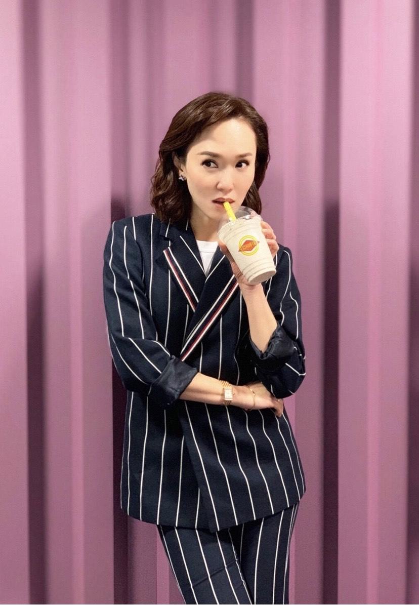 范文芳是个有品位的女人,穿条纹套装出席活动干练利落,精致高级