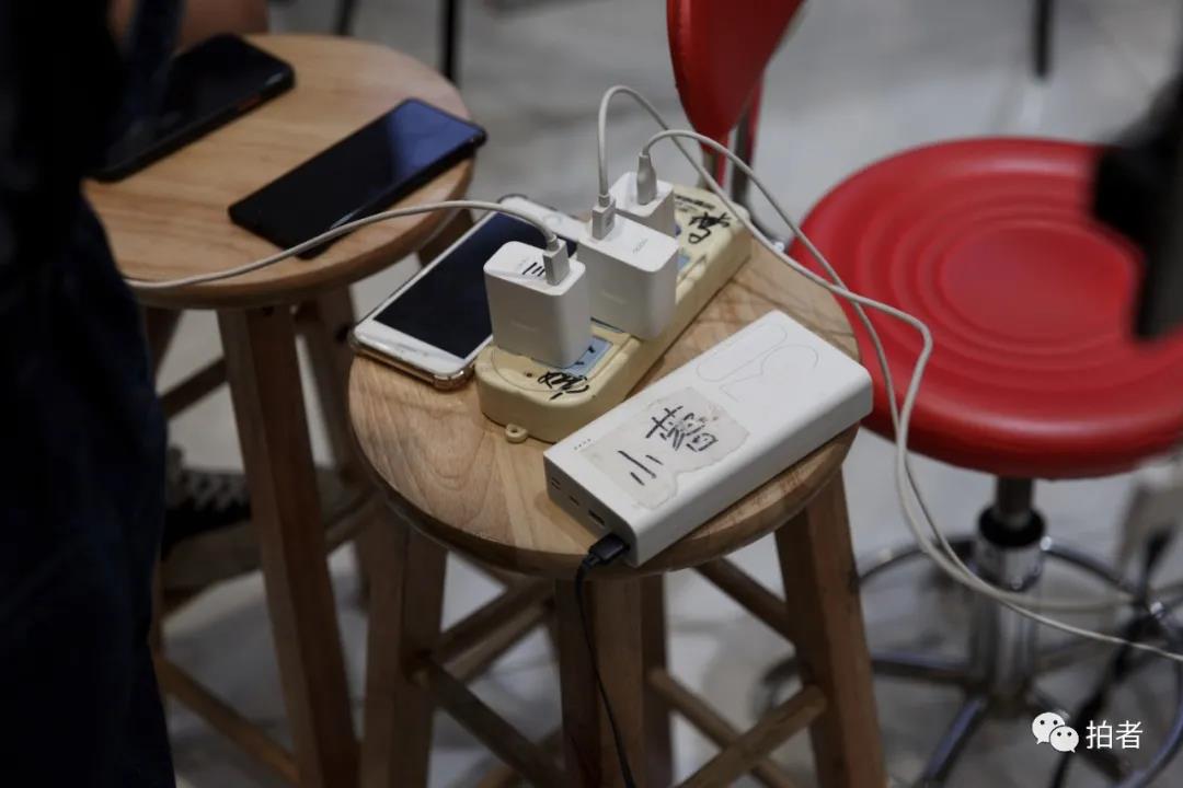 △9月25日，广州万佳服装批发市场，档口内的插排插满了手机充电器。