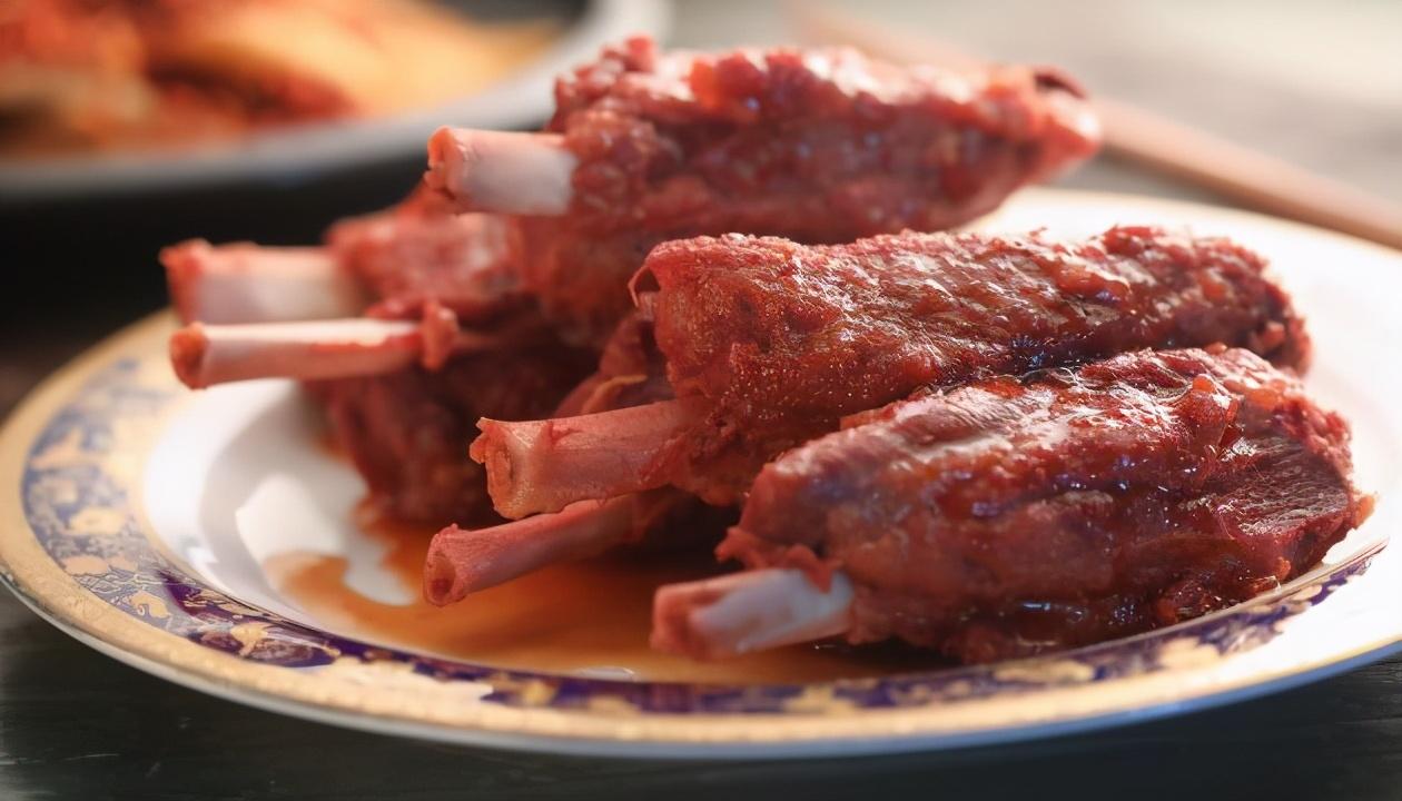 红米炖子排」宴客大菜,将炸好的猪棒骨下锅放进红糟酱汁卤制40分钟后