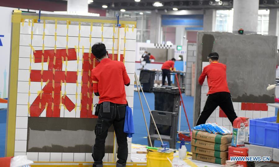 Contestants tile walls during the first vocational skills competition in Guangzhou, south China's Guangdong Province, Dec. 10, 2020. The competition, running from Thursday to Sunday, will see over 2,500 contestants taking part in 86 catogories of contests. (Xinhua/Lu Hanxin)