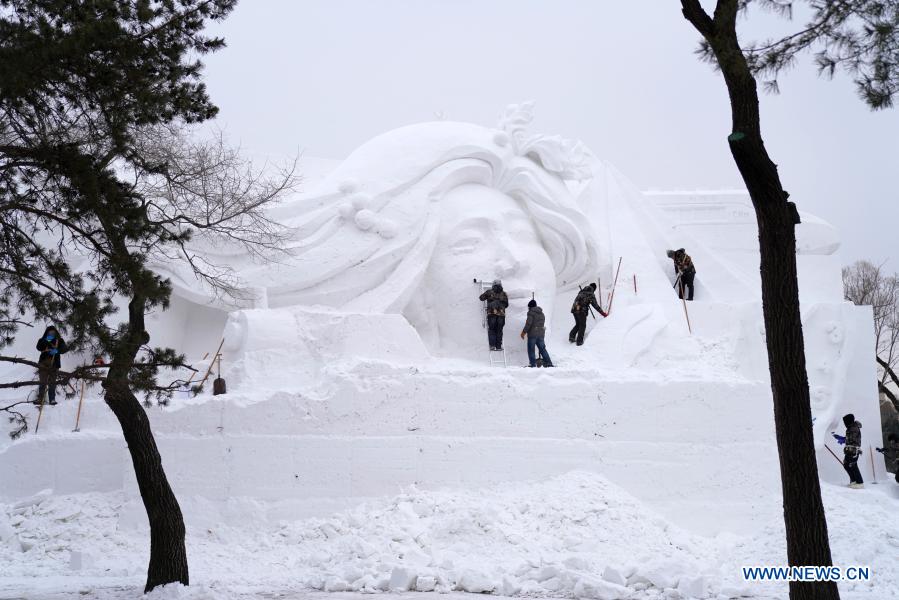 Snow sculptors process an artwork in the compound of the 33rd Harbin Sun Island International Snow Sculpture Art Exposition in Harbin, northeast China's Heilongjiang Province, Dec. 10, 2020. The event is expected to open in mid-to-late November. (Xinhua/Wang Jianwei)