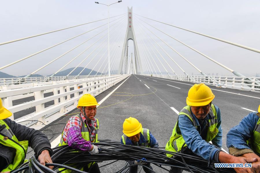 Workers work at the construction site of the Hezhou-Gaolan Port Highway on the Pearl River estuary in south China's Guangdong Province, Dec. 9, 2020. Upon completion, the 35-km highway will be an important channel linking the west bank of the Pearl River estuary and the Guangdong-Hong Kong-Macao Greater Bay Area. (Xinhua/Liu Dawei)