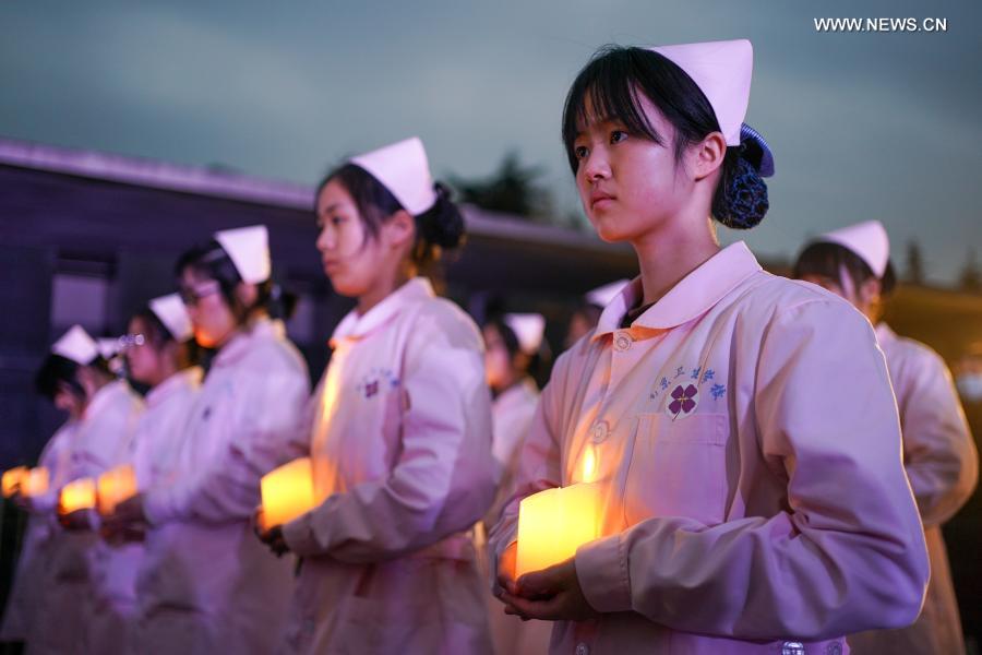 People take part in a candlelight vigil in commemoration of victims of the Nanjing Massacre on the occasion of the seventh national memorial day at the Memorial Hall of the Victims of the Nanjing Massacre by Japanese Invaders in Nanjing, capital of east China's Jiangsu Province, Dec. 13, 2020. (Xinhua/Li Bo)