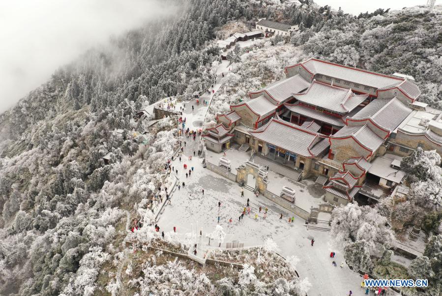 Aerial photo shows people having fun at the snow covered Hengshan Mountain scenic area in Hengyang, central China's Hunan Province, Dec. 15, 2020. (Photo by Cao Zhengping/Xinhua)