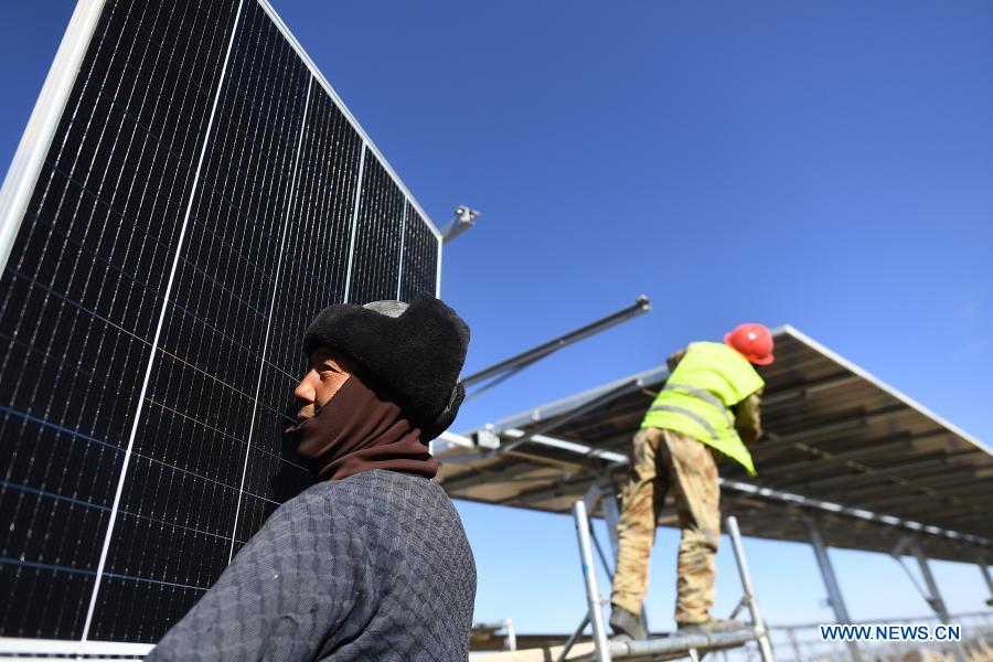 Workers install a solar power unit at the construction site of a 300-MW photovoltaic electricity project of the China Datang Corporation Ltd. in Gonghe County, Tibetan Autonomous Prefecture of Hainan in northwest China's Qinghai Province, Dec. 15, 2020. (Xinhua/Zhang Hongxiang)