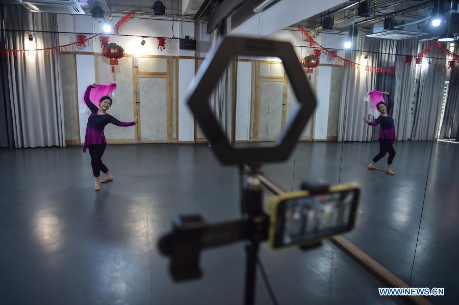 The 63-year-old Xin Lihua dances while recording a lesson on video at a public cultural service center in Haidian District of Beijing, capital of China, April 15, 2020. The year 2020 is a juncture where China is wrapping up the plan for the 2016-2020 period and preparing for its next master plan. In 2020, China stepped up efforts to shore up weak links regarding people's livelihoods. A slew of measures has been rolled out to address people's concerns in employment, education, basic medical services, the elderly care, housing, public services, etc. (Xinhua/Peng Ziyang)