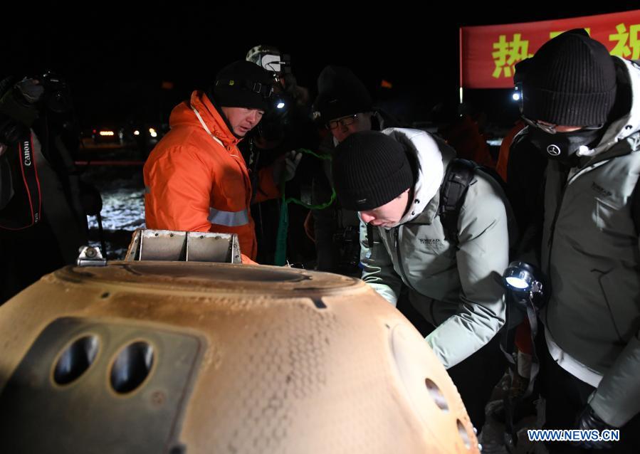 Staff members work at the landing site of the return capsule of China's Chang'e-5 probe in Siziwang Banner, north China's Inner Mongolia Autonomous Region, on Dec. 17, 2020. The return capsule of China's Chang'e-5 probe touched down on Earth in the early hours of Thursday, bringing back the country's first samples collected from the moon, as well as the world's freshest lunar samples in over 40 years. (Xinhua/Lian Zhen)