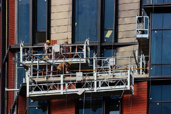 致敬在凛冽刺骨的寒风中站在空中吊篮上作业的幕墙装饰工人