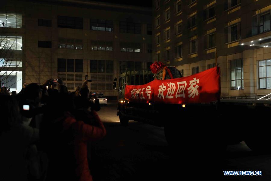 People celebrate the arrival of the return capsule of China's Chang'e-5 probe at China Academy of Space Technology in Beijing, capital of China, Dec. 17, 2020. The capsule was airlifted to Beijing on Thursday night, and the moon samples will be delivered to the research team for analysis and study. (Xinhua/Jin Liwang)
