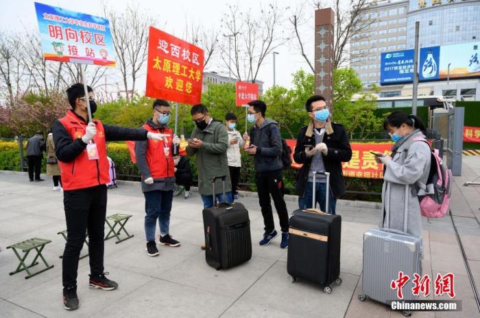 原料图:4月10日,山西太原火车站,高校返校弟子在出站口批准体温检测。当日,山西省始批高校本硕博卒业年级开学复课。 中新社记者 韦亮 摄