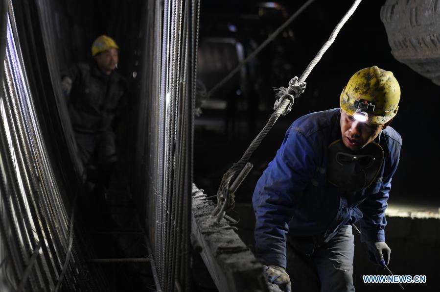 Staff members work at Tunnel Dajin No.1 of the Huanggang-Huangmei high-speed railway in Huanggang, central China's Hubei Province, Dec. 22, 2020. The 605-meter-long Tunnel Dajin No.1 was successfully drilled through on Tuesday. So far, all the 15 tunnels along the Huanggang-Huangmei high-speed railway have been holed through. The 125.12-km Huanggang-Huangmei high-speed railway in Hubei Province is designed to run at a speed of 350 km per hour. (Xinhua/Cheng Min)