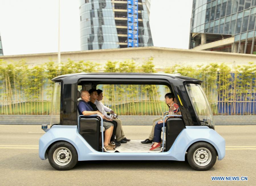 A competition car of i-Vista Self-driving Cars Challenge carrying citizens runs on a road during an experience day event in southwest China's Chongqing Municipality, Aug. 28, 2019. With the development of new technologies such as the 5G, artificial intelligence and BeiDou Navigation Satellite System (BDS), unmanned technology is injecting impetus into traditional industries as well as making people's life easier and more convenient in China, and bringing about profound innovation and transformation. From commerce, agriculture, transportation, industrial production to environmental protection, China has been embracing this emerging technology in various fields in recent years as it strives to promote high-quality development. (Xinhua/Liu Chan)