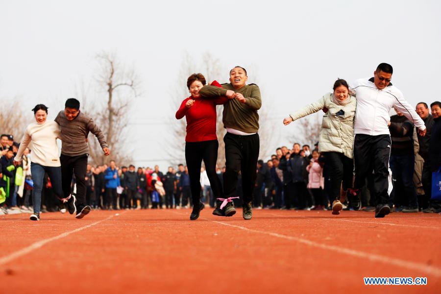 Farmers take part in a walking game in Yaogou Township of Sihong County in Suqian, east China's Jiangsu Province, Dec. 27, 2020. The fun games, held annually in Yaogou Township before the New Year's Day since 2018, consist of eight interesting competitions which are close to farmers' life this year. (Photo by Xu Changliang/Xinhua)