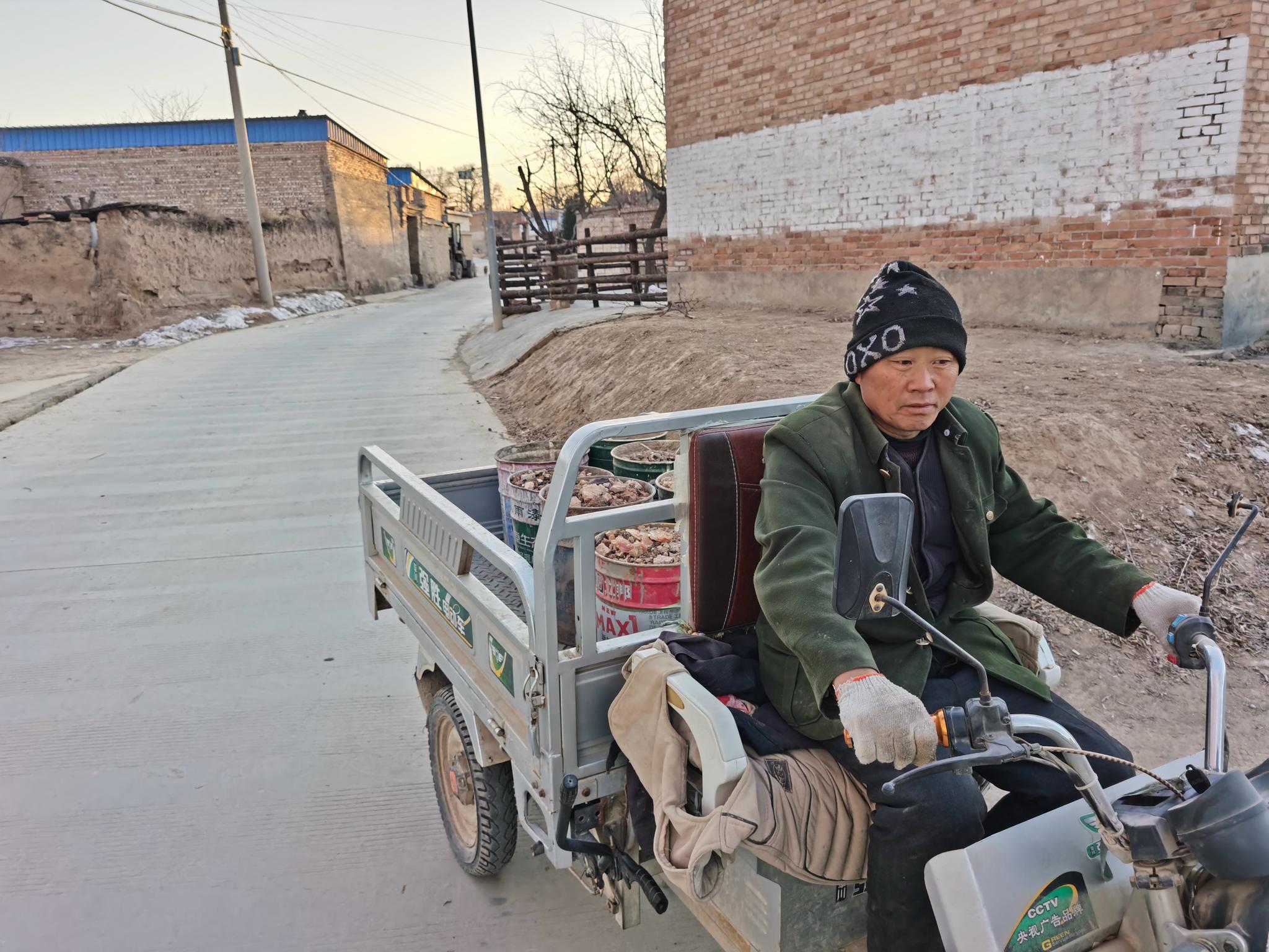 赵四明开着小三轮倒垃圾.