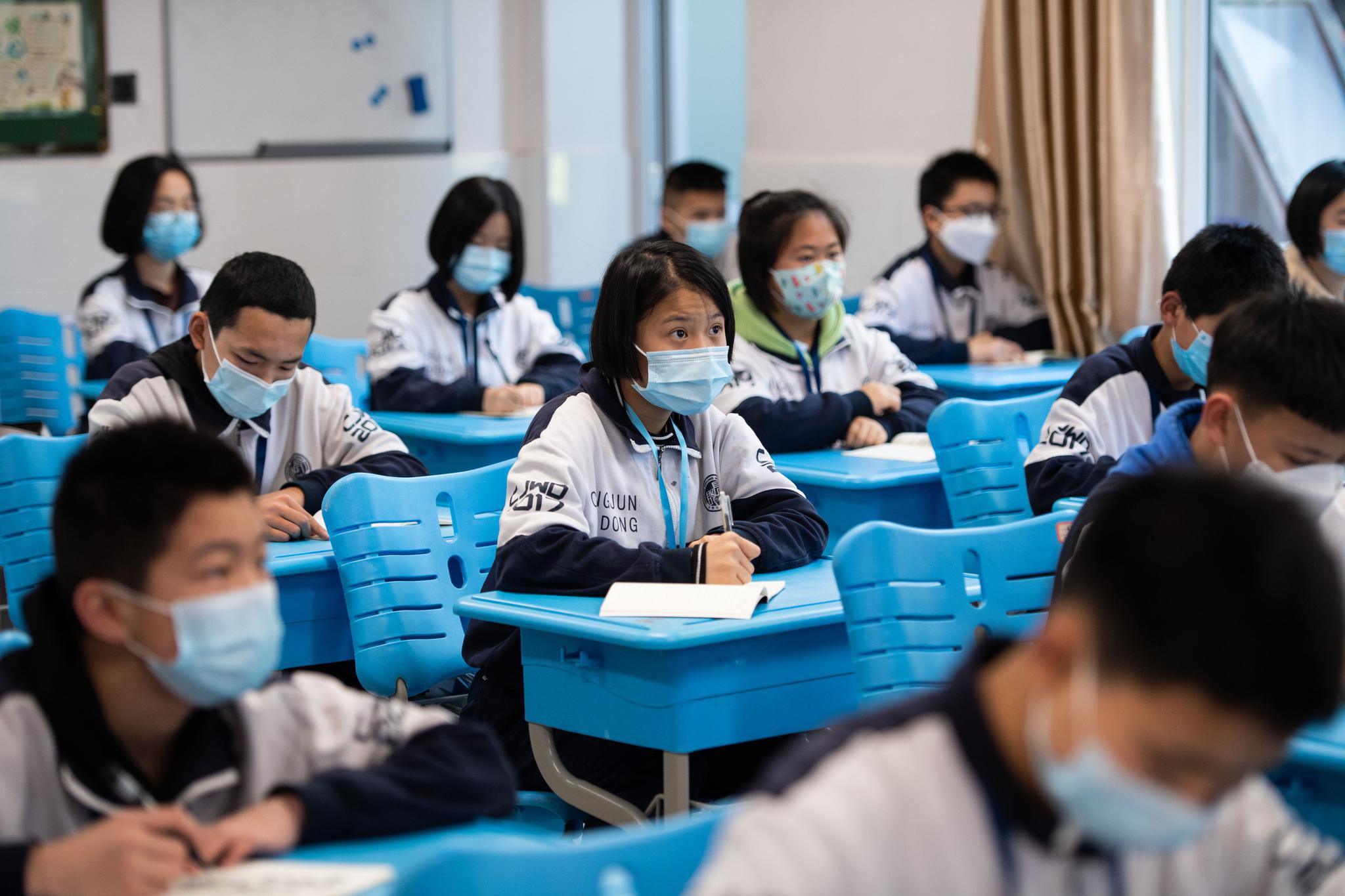 4月13日,在长沙宁乡市长郡沩东中学,学生进入宿舍前接受体温测量.