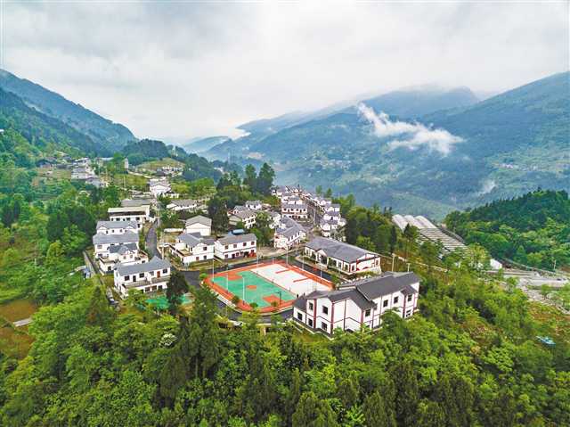 彭水县三义乡龙阳村,一位村民带着孩子走在梯田旁的村道上.