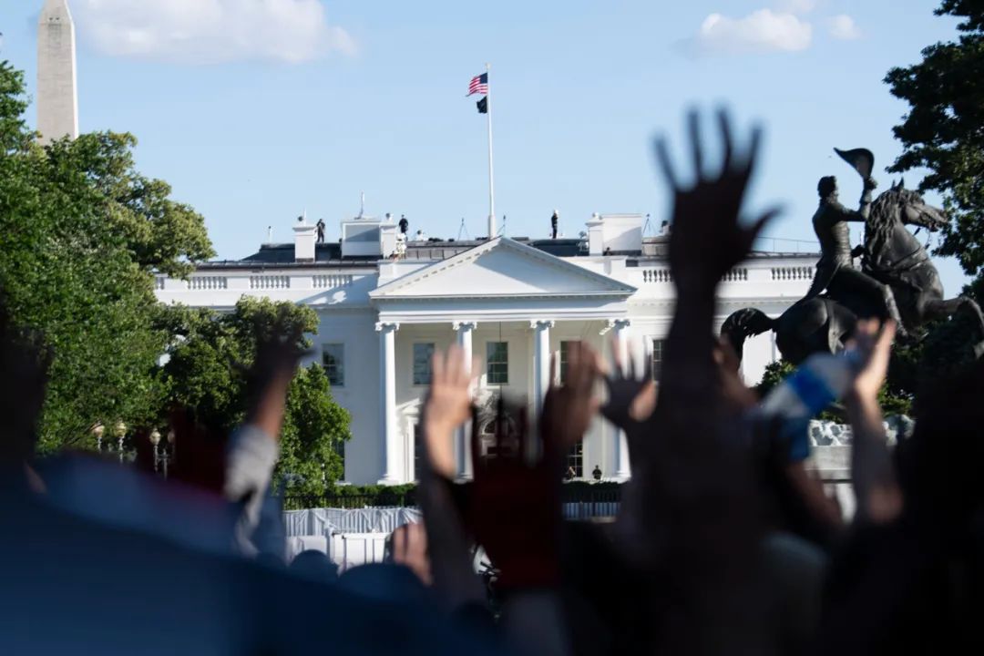  5月31日，在美国首都华盛顿，人们在白宫前举手抗议。新华社记者 刘杰 摄