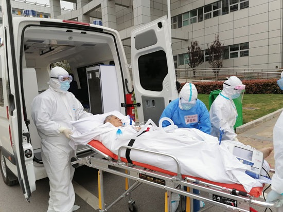 李刚,夏金根和同事转运一位危重新冠肺炎患者到武汉同济医院.