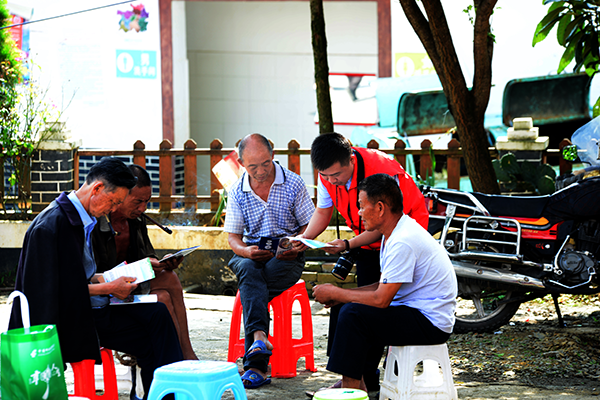 图为工作人员向群众宣讲金融知识.