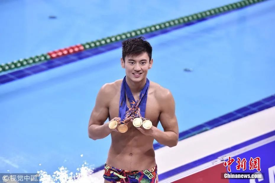 资料图：图为2014年9月26日晚，仁川亚运会游泳比赛在文鹤游泳馆落幕，宁泽涛展示自己获得的金牌。图片来源：视觉中国