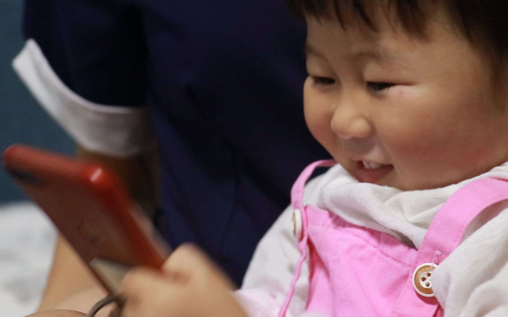 刘月的女儿田野在手机上和爸爸交流。新京报记者 景如月 摄