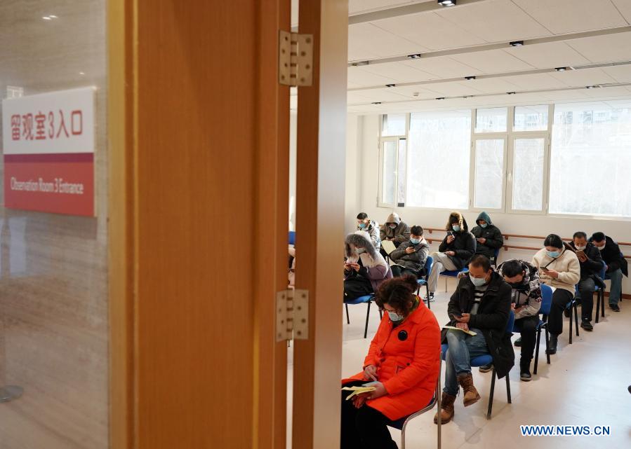 People wait in the observation room after receiving the COVID-19 vaccines at a healthcare center in Honglian Community in Xicheng District of Beijing, capital of China, Jan. 3, 2021. Beijing has started administering COVID-19 vaccines among specific groups of people with higher infection risks. Nine groups of people aged 18 to 59 will receive the vaccine before the Spring Festival of 2021, which falls on Feb. 12. These include frontline customs inspectors of imported cold-chain goods and personnel working in the overseas and domestic transportation sector. (Xinhua/Zhang Chenlin)