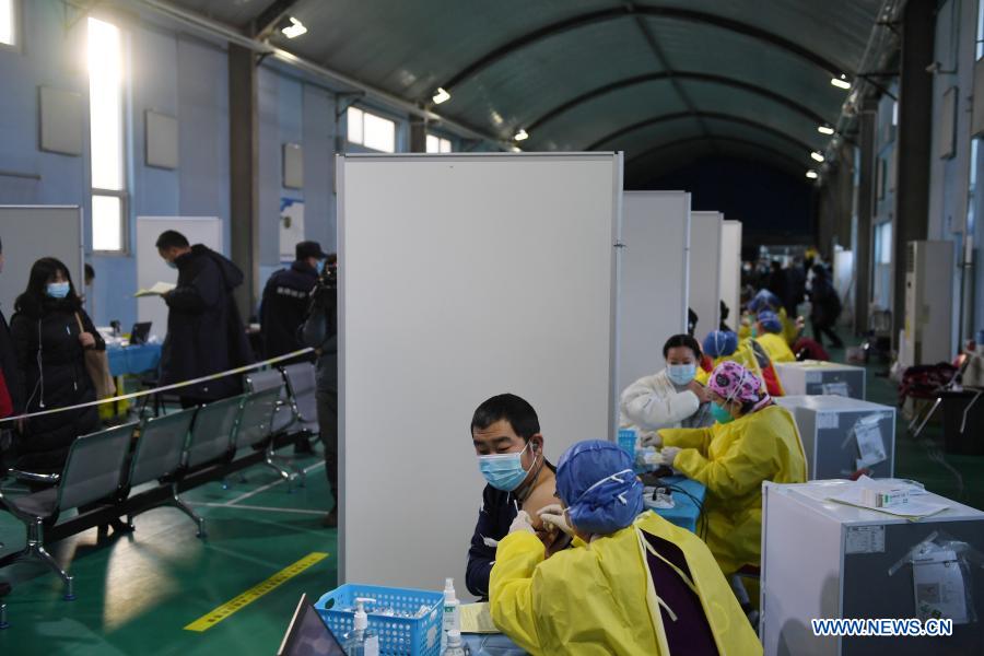 People receive their COVID-19 vaccinations at a temporary vaccination site in Haidian District of Beijing, capital of China, Jan. 6, 2021. (Xinhua/Ju Huanzong)
