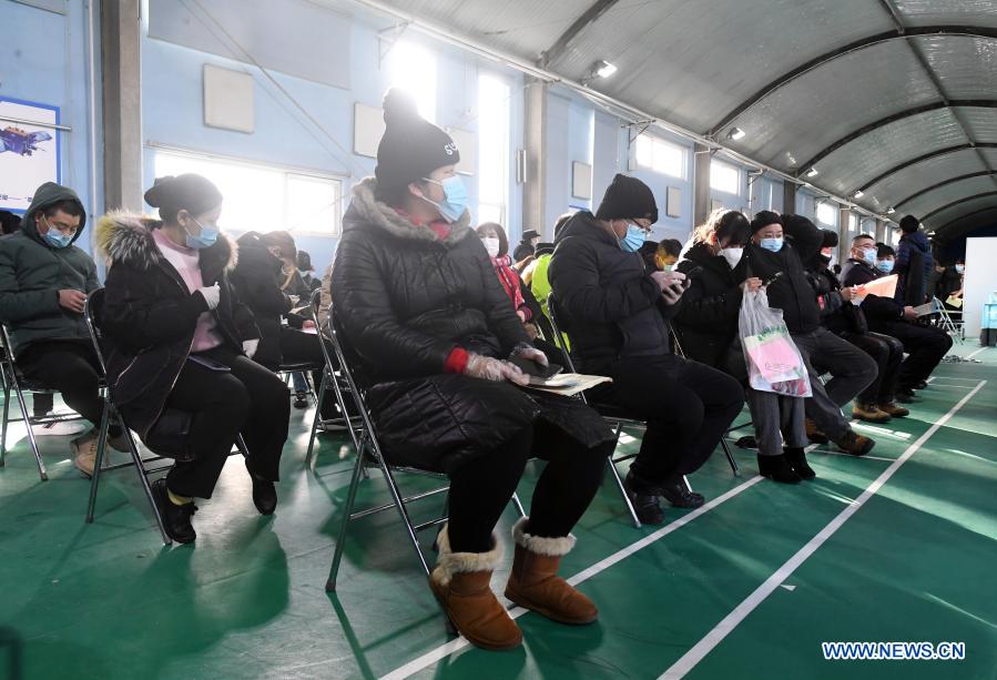 People wait in an observation area after receiving their COVID-19 vaccinations at a temporary vaccination site in Haidian District of Beijing, capital of China, Jan. 6, 2021. (Xinhua/Ren Chao)