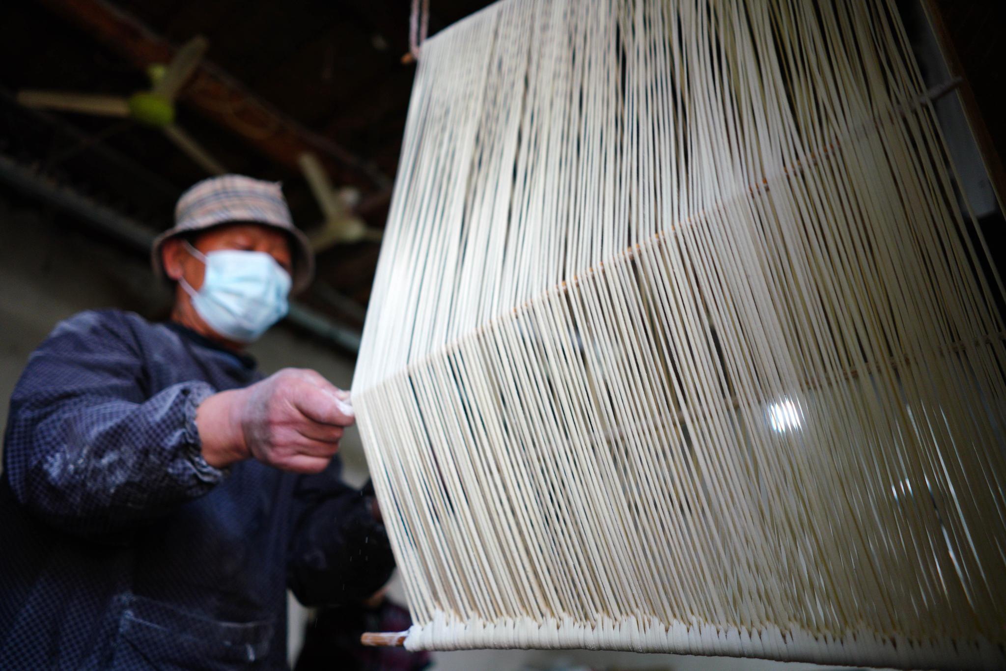3月10日,河北省新河县望腾村村民侯景涛在晾晒挂面(无人机照片).