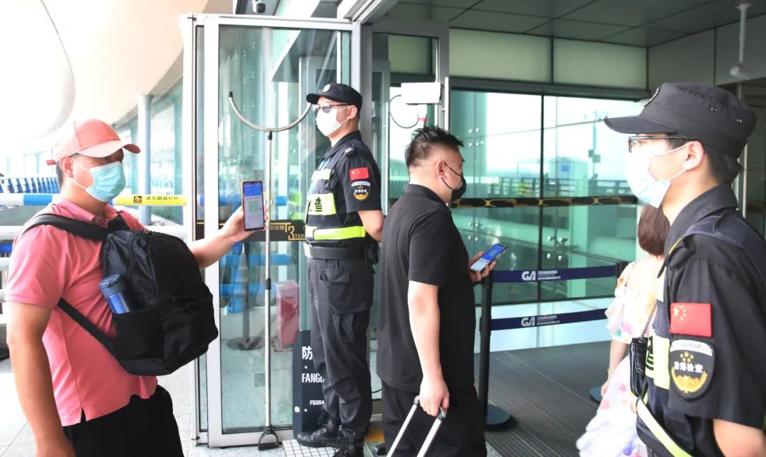 乘客进入航站楼前配合防疫检查 重庆江北国际机场供图