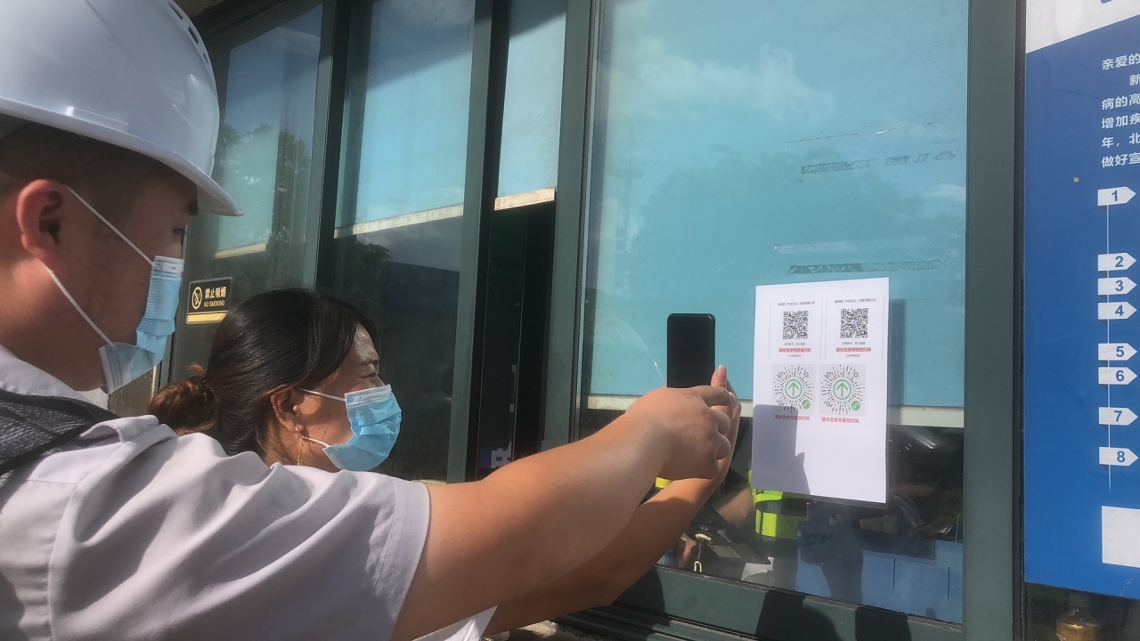 宁波百川港通国际物流有限公司集卡司机正在入库前扫码.