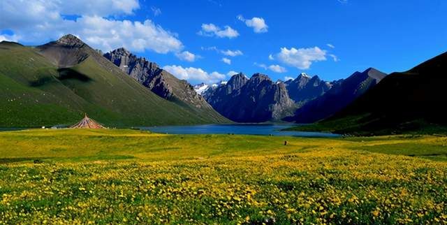 青海久治县,有年宝玉则神山,山峰壮观,湖泊清澈,还有遍地鲜花