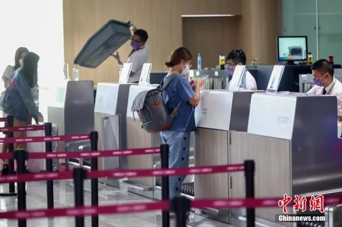 乘客在南京禄口国际机场T1候机楼内办理乘机手续。 泱波 摄