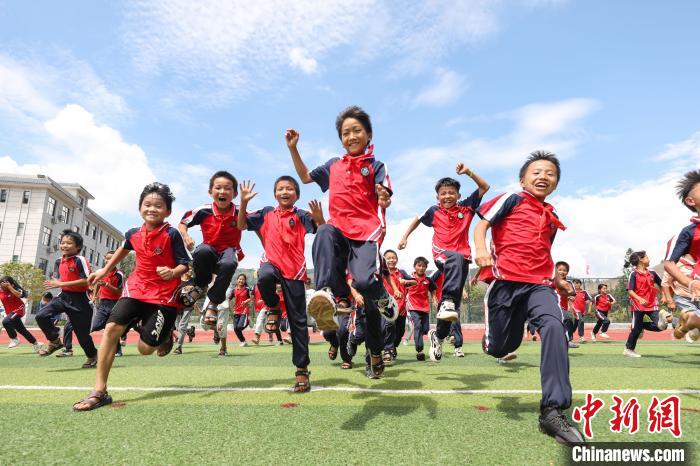 图为大歹小学学生在学校足球场奔跑 瞿宏伦 摄