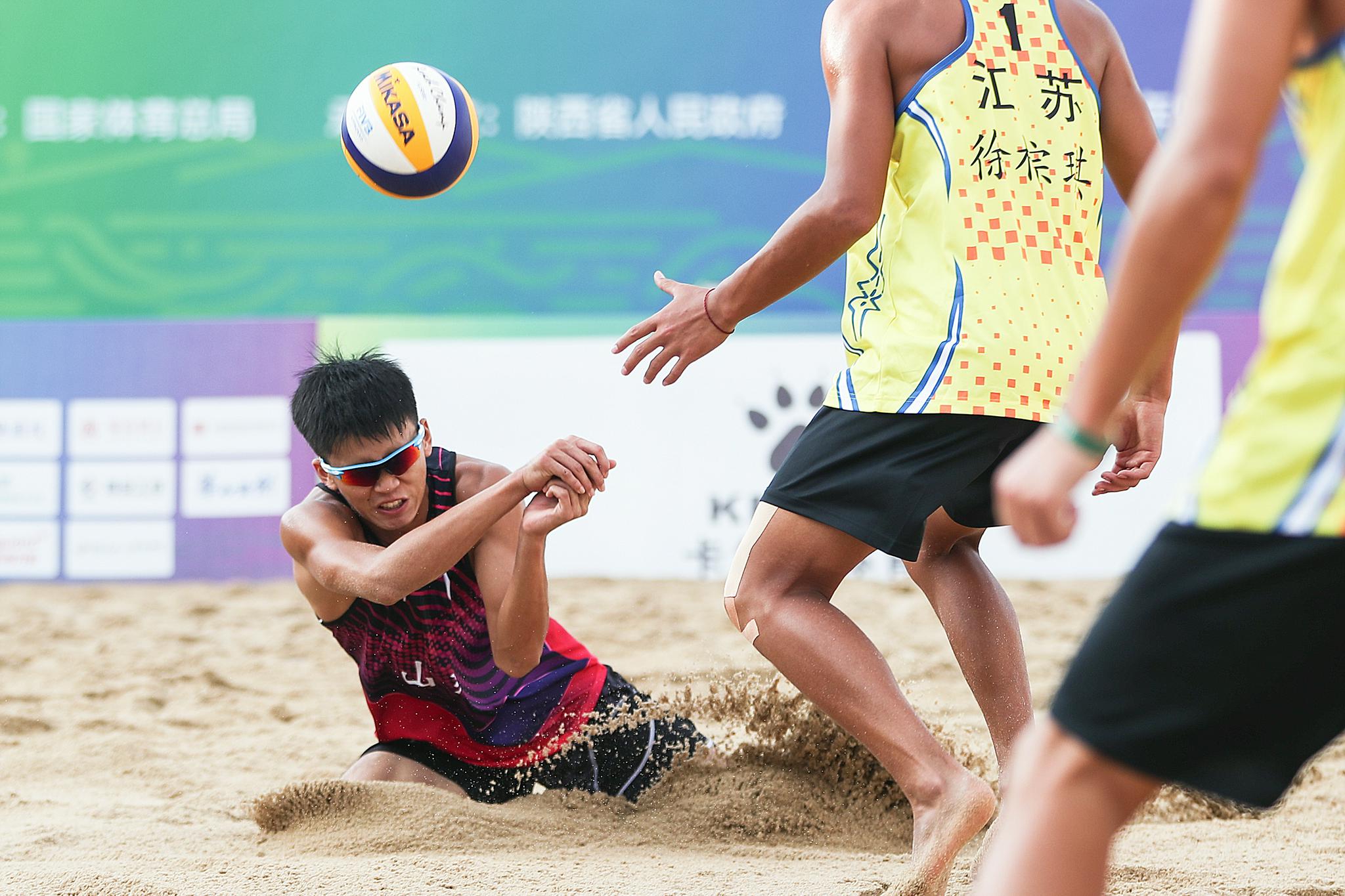 9月22日,山东青年一队球员王志合(左)在比赛中接球.