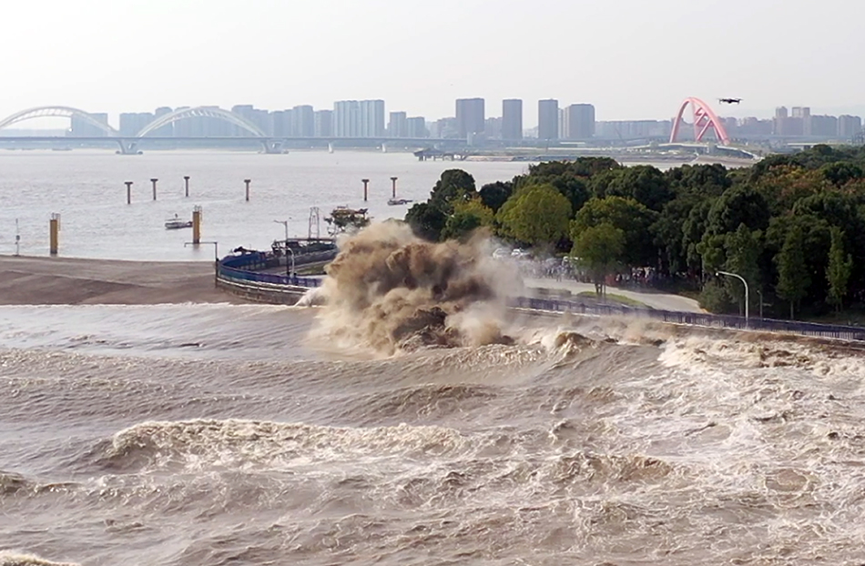 在杭州下沙江堤上，众多市民和游客争睹钱江大潮的壮观景象。