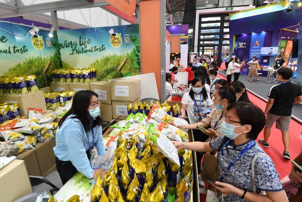 　　在广西南宁国际会展中心，第18届中国—东盟博览会上，参观者在选购商品。新华社