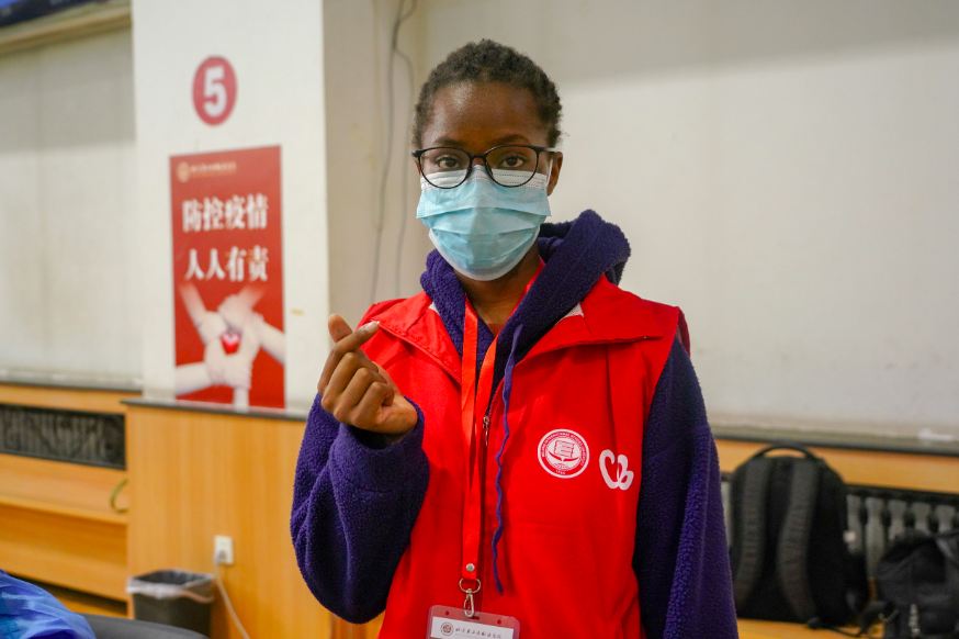 高校师生打加强针，现场有位忙碌的留学生“红马甲”休闲区蓝鸢梦想 - Www.slyday.coM