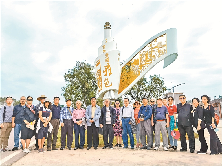 深圳新闻界老同志在"雅色新画卷"雕塑前合影.