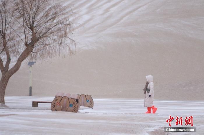 游客在甘肃省敦煌市鸣沙山月牙泉景区游览。中新社发 张晓亮 摄 图片来源：CNSPHOTO