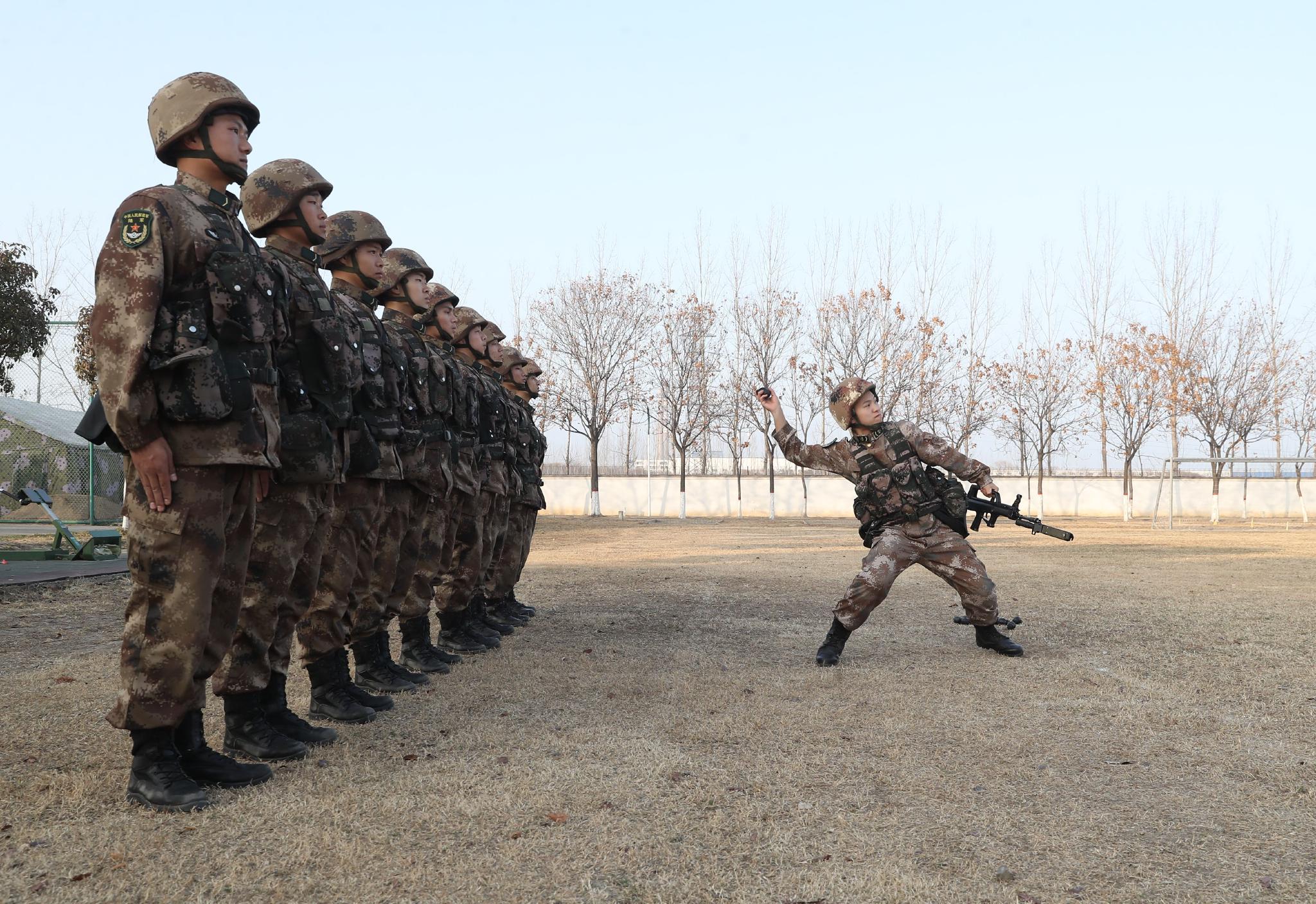 ▲12月14日，王存绿在部队进行日常训练，他正在为新兵演示投掷手榴弹的动作。 新京报记者 王飞 摄